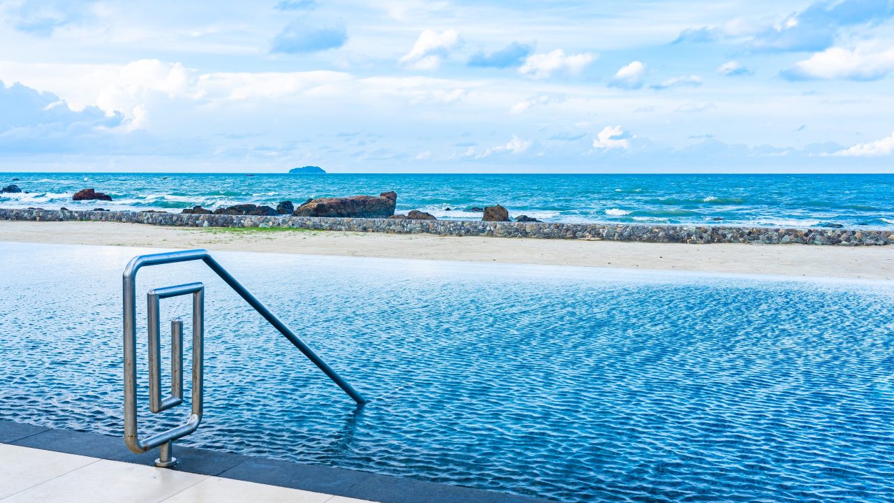 Beautiful outdoor swimming pool in hotel resort with white cloud Beautiful outdoor swimming pool in hotel resort with white cloud and blue sky for leisure relax in holiday vacation