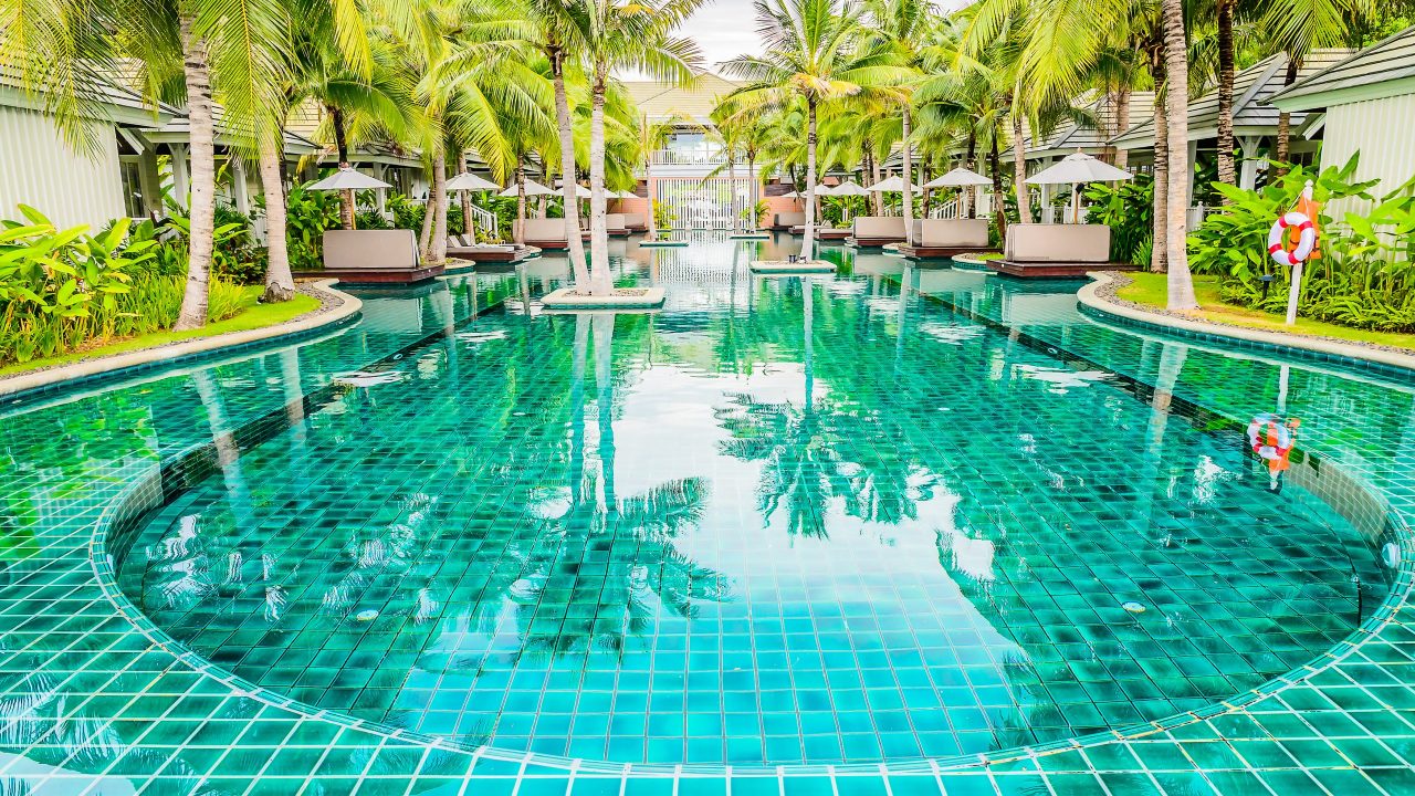 Outdoor Swimming pool in hotel resort for summer vacation backgr Outdoor Swimming pool in hotel resort for summer vacation background